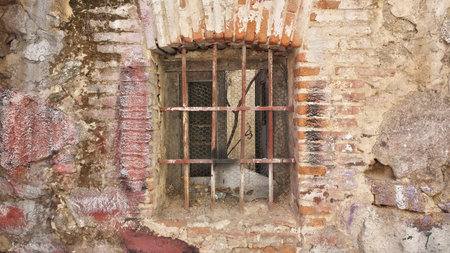 iron bars on the window of an old houseの写真素材