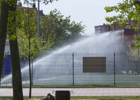 sprinkler irrigation on a sports fieldのeditorial素材