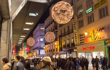MADRID,SPAIN - DECEMBER 18: The streets of Madrid are filled with lights and people doing their Christmas shopping December 18, 2014 in Madrid Spainのeditorial素材
