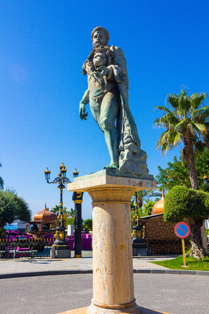 bronze statue of naked man with a lion headの写真素材