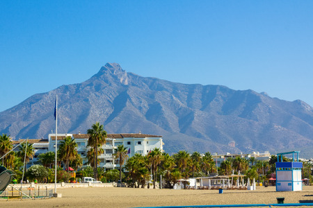 Beach with mountains behind in Puerto Banus, Malaga, Spainの写真素材