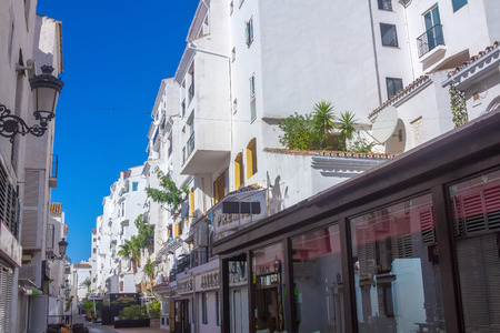 streets with whitewashed buildings typical of Puerto Banus, Malaga Spainのeditorial素材
