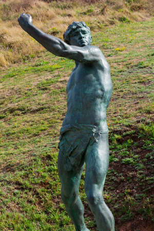 Old bronze statue of a young Greekの写真素材