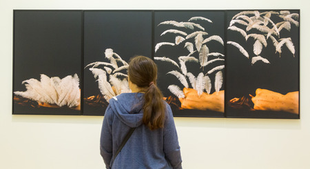 young girl observed an abstract paintingの写真素材