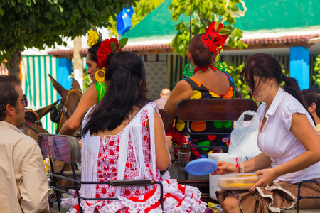 ANDUJAR,SPAIN - September, 6: Women typical Sevillian flamenca suits, walking in the car in the Horse Fair on September, 6, 2014 in Andujar, Spainのeditorial素材