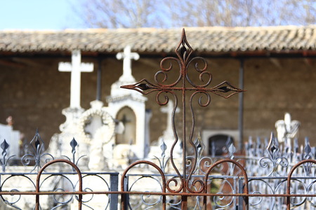 old cross carved in stone on a graveの写真素材