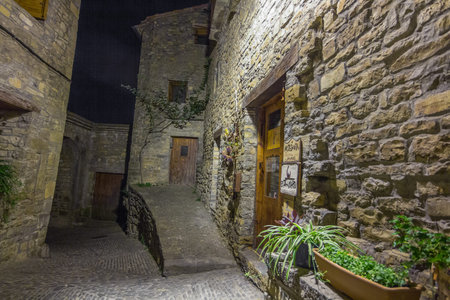 Ainsa medieval village of the Pyrenees with beautiful stone houses at night, Huesca, Spain