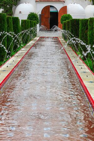 Elongated fountain with many small jets of waterの写真素材