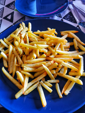 blue plate full of french fries