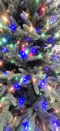 a wallpaper with a Christmas tree with colored lightsの写真素材