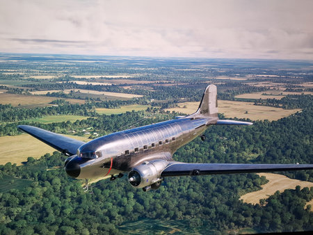 DC-3 plane flying over an area of â€‹â€‹crops and trees