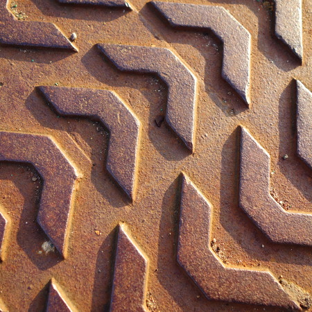 Sunlit Manhole Cover Patternの写真素材