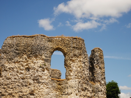 Tall ruined walls of Reading Abbey, Berkshire, England against blue skyの写真素材