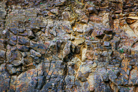 Black and brown rocky cliff face texture 01の写真素材