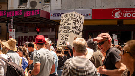 Melbourne, Victoria Australia - November 20 2021: Man holds up a sign "A Nation of Sheep will Soon Have A Government of Wolves Sack Nazi Dan" Bourke Street Freedom March Peaceful Protestのeditorial素材