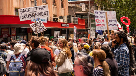 Melbourne, Victoria Australia - November 20 2021: Peaceful Protestors march holding up signs at Freedom March and Kill the Bill Peaceful Protest Rally on Bourke Streetのeditorial素材