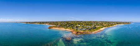 Aerial shot of Daveys Bay Pelican Point, Mount Eliza coastal seascape with turquoise sea and clear blue sky aerial panoramicの写真素材