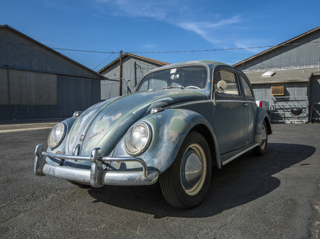 A classic VW bug parked in front of hangars at the Santa Paula Wings and Wheels event on May 4th, 2014のeditorial素材