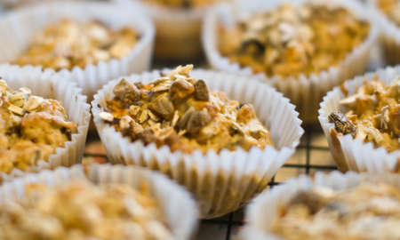 Oatmeal muffins cooling on a wire rack.の写真素材