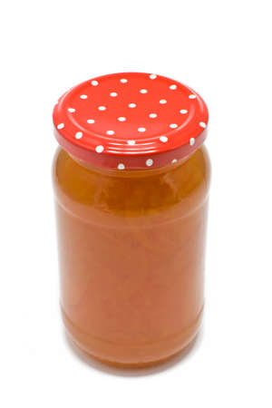 A jar of homemade seville orange marmalade isolated on a white backgroundの写真素材