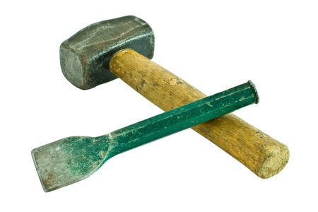A well used hammer and chisel isolated on a white background