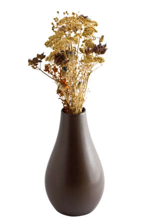 A brown ceramic vase  containing dried flowers isolated on a white backgroundの写真素材