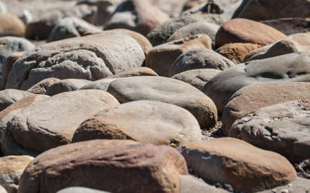 A close-up of pitted and smooth beach pebbles found at Cape Point, Cape Town, South Africa.の写真素材