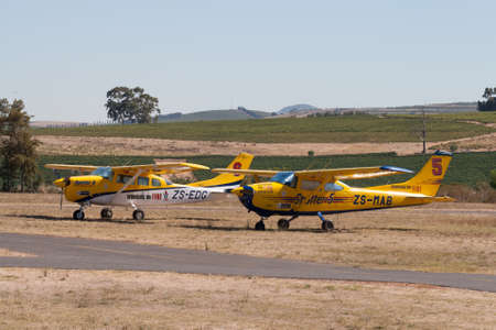 Stellenbosch Airfield, South Afirca - February 08, 2012: Two parked Cessna spotter aircraft of South African firefighting organisation Working on Fire (WoF) at Stellenbosch airfield, South Africa. WoF trains young people from marginalised communities as sのeditorial素材