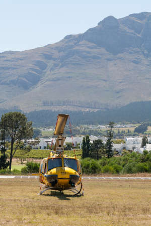 Stellenbosch Airfield, South Afirca - February 08, 2012: A parked Bell UH-1 Huey of South African firefighting organisation Working on Fire (WoF) at Stellenbosch airfield, South Africa. WoF trains young people from marginalised communities as skilled wildのeditorial素材