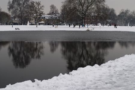 A lake surrounded by snowの写真素材