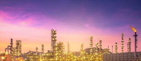 Close-up view Oil and gas industrial refinery zone,Detail of equipment oil pipeline steel with valve from large oil storage tank at twilight -imageの写真素材