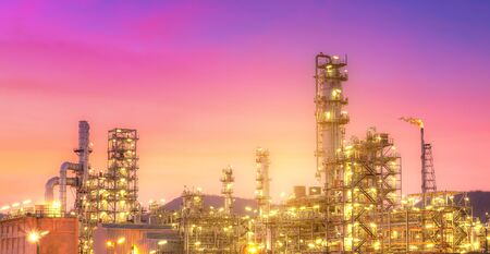 Close-up view Oil and gas industrial refinery zone,Detail of equipment oil pipeline steel with valve from large oil storage tank at twilight -imageの写真素材