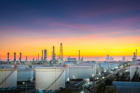 Close-up view Oil and gas industrial refinery zone,Detail of equipment oil pipeline steel with valve from large oil storage tank at twilight -imageの写真素材