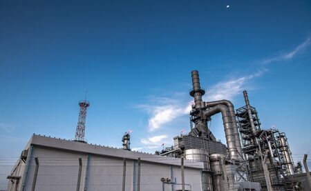 Oil and gas refinery plant form industry petroleum zone,Refinery equipment pipeline steel at sunrise. -imageの写真素材