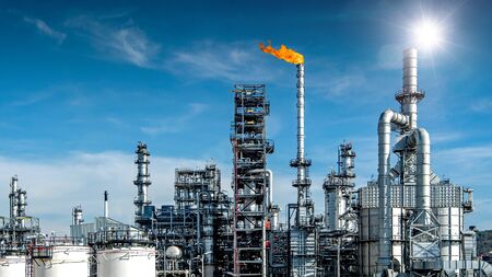 Close-up view Oil and gas industrial refinery zone,Detail of equipment oil pipeline steel with valve from large oil storage tank at cloudy sky. -imageの写真素材