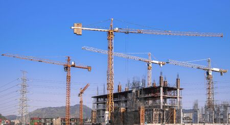 Lots of tower Construction site with cranes and building with blue sky background.の写真素材