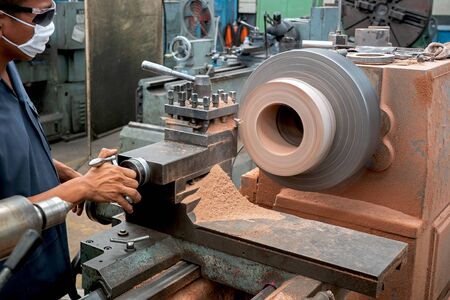 Professional workers are doing the milling process for metal parts, metal machinery in large industrial plants-imageの写真素材