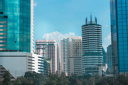 a Lot of Buildings with blue sky near the parkの写真素材