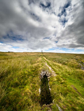 This old ruined flue winds it's way over the moors, a reminder of the toil of the lead miners. Grassington moor lead mines. Yorkshire Dales National Parkの写真素材