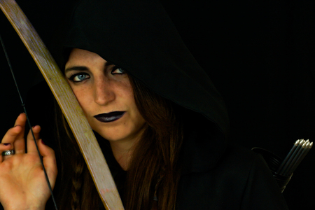 A young female dressed as an elf with a wooden recurve bow and arrowの写真素材