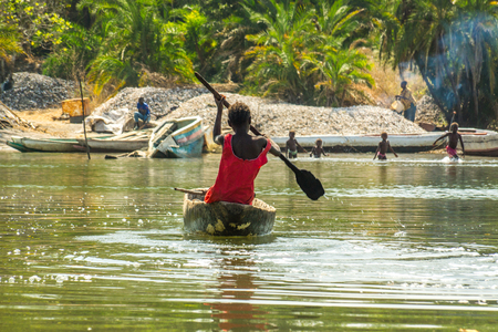 African children practice canoeing in the River Gambia near Makasutu forest in Gambia, West Africaの写真素材