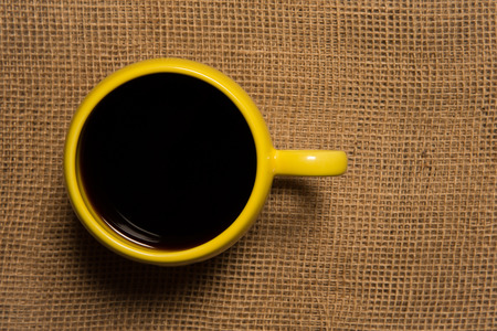 Coffee Mug Close Up   Top view of yellow mug on burlap   Warm tones の写真素材