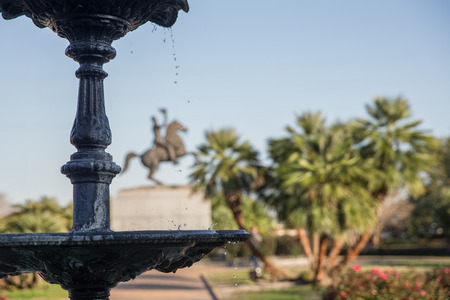 Jackson Square wrought iron water fountain and water droplets in the foreground with Andrew Jackson statue in background. の写真素材