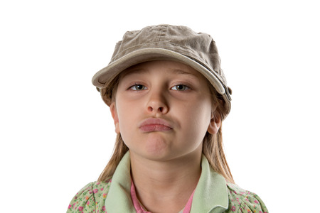 Sad - Girl in green hat pouting at camera.  Isolated on white.の写真素材
