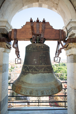 PISA, ITALY - August 2, 2015:  Medieval bell atop the Leaning Tower of Pisa in Tuscany, Italy.  The Tower of Pisa is one of Italy's most iconic tourist attractions and is famous worldwide for its unintended tilt.のeditorial素材