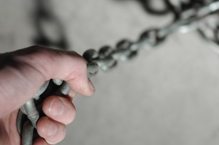 Strong hand on chainの写真素材
