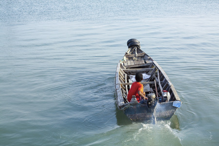 Penang, Malaysia - April 12, 2010: An young man in penang sailing home after all night of fishing. Fishing is main way to survive in Penang, Malaysia.のeditorial素材