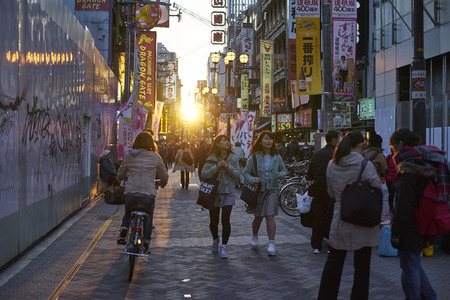 Osaka,Japan - 25 March,2015: Crowds walk below the signs of Dotonbori. With a history reaching back to 1612, the district is now one of Osaka's primary tourist destinations.のeditorial素材