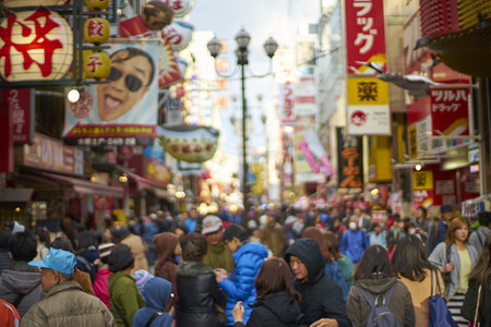 Osaka,Japan - 25 March,2015: Crowds walk below the signs of Dotonbori. With a history reaching back to 1612, the district is now one of Osaka's primary tourist destinations.のeditorial素材
