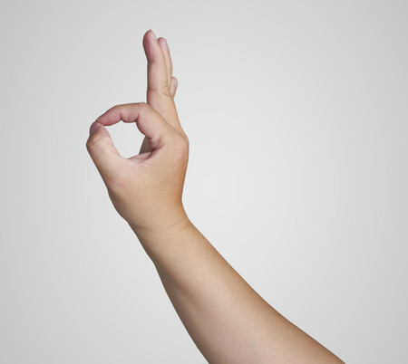 hand in ok sign on a white isolated backgroundの写真素材